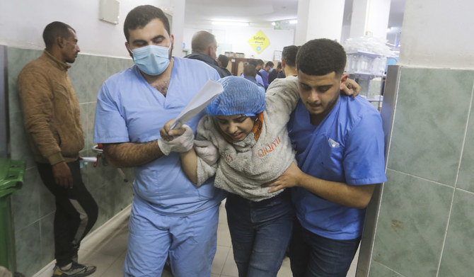 Palestinians wounded in the Israeli bombardment of the Gaza Strip arrive at a hospital in Rafah, on Wednesday, Dec. 6, 2023. (AP