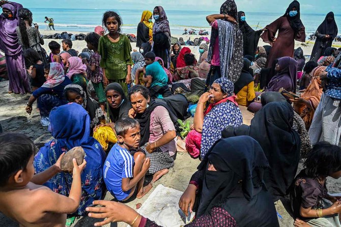 Rohingya refugees gather and rest at a beach in Pidie district in Indonesia’s Aceh province on Dec. 10, 2023. (AFP)