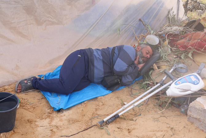 A displaced Palestinian man rests next to a tent at a camp in Rafah in the southern Gaza Strip Dec. 10, 2023. (Reuters)