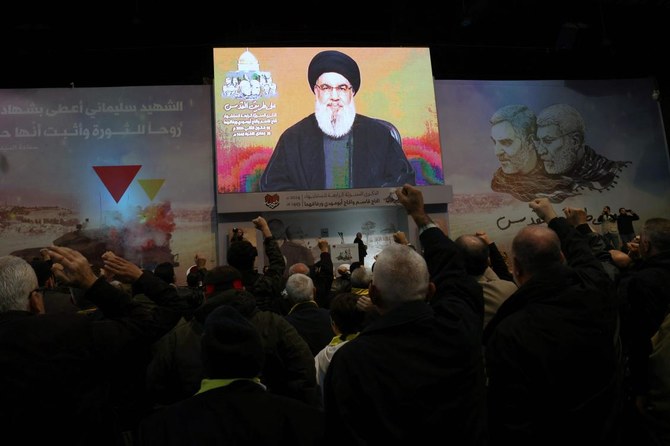 People watch the televised speech of Lebanon’s Hezbollah chief Hasan Nasrallah.