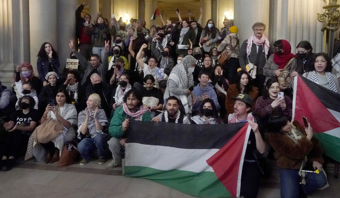 Pro-Palestinian supporters cheer after a San Francisco Board of Supervisors meeting in San Francisco, Tuesday, Jan. 9, 2024. (AP