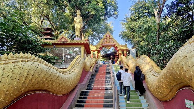 Tourists climb the stairs of Rangkut Monastery, the oldest Buddhist monastery in Bangladesh, located in Ramu, Cox’s Bazar.