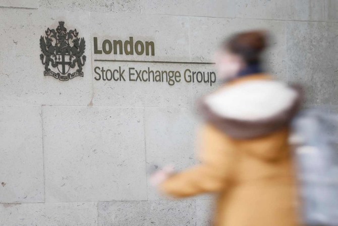 A pedestrian walks past the logo for the London Stock Exchange Group outside the stock exchange in London. (File/AFP)