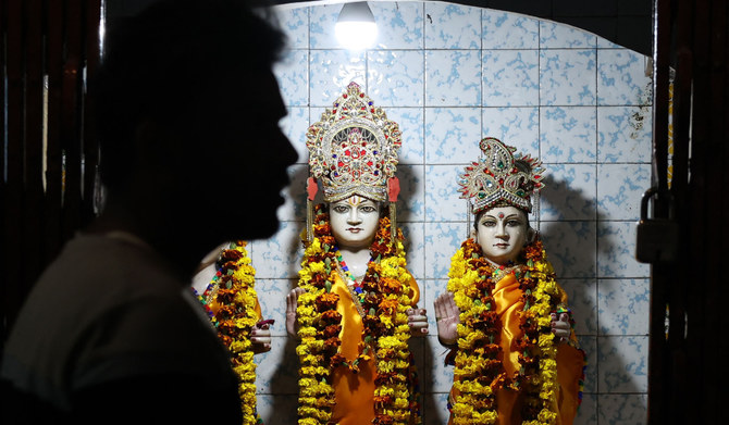 A man walks past the idols of Hindu deities Ram and Sita at a temple in Varanasi on February 23, 2024. (AFP)