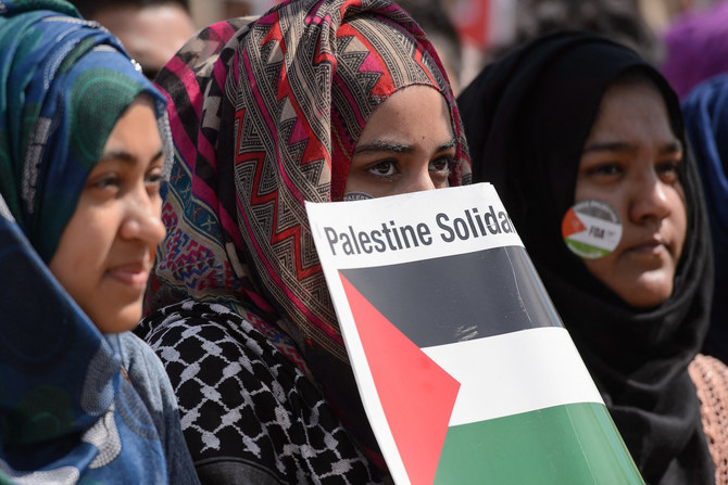 Pro-Palestinian demonstrators wave placards and Palestinian flags at a mass rally in support of Gaza in London. (File/AFP)