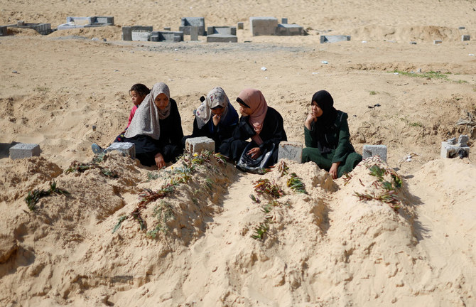 Palestinians visit a cemetery, amid the ongoing conflict between Israel and Hamas, in Rafah in the southern Gaza Strip.
