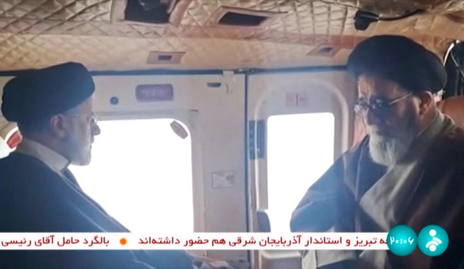 Video footage shows Iran's President Ebrahim Raisi (L) with an unidentified memeber of his delegation on board a helicopter.
