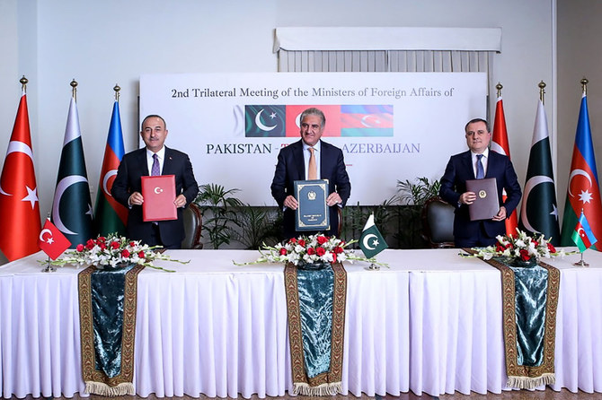 Pakistan's Foreign Minister Shah Mahmood Qureshi (C), Turkish Foreign Minister Mevlut Cavusoglu (L) and Azerbaijan Foreign minister Jeyhun Bayramov pose for a photograph after the signing agreement ceremony during the second trilateral meeting in Islamabad on January 13, 2020. (Pakistan Foreign Ministry via AFP)
