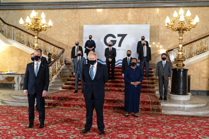 Britain's Prime Minister Boris Johnson (C) and Britain's Foreign Secretary Dominic Raab (2L), posing for a family photograph with other delegates during the G7 foreign ministers meeting in London on May 5, 2021. (AFP)