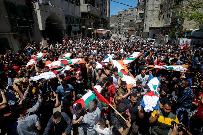 Mourners carry the bodies of Palestinians. who were killed amid a flare-up of Israeli-Palestinian violence, during their funeral at the Beach refugee camp in Gaza City on May 15, 2021. (REUTERS)