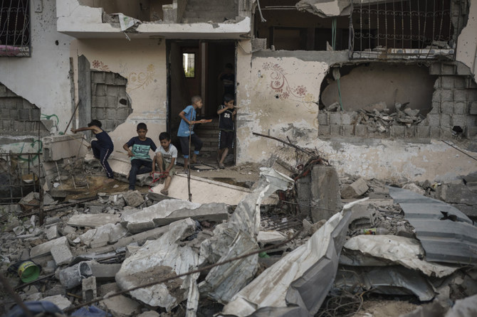 Palestinian children play among the rubble of homes in Beit Hanoun, Gaza Strip, that were destroyed by airstrikes during an 11-day war between Gaza's Hamas rulers and Israel. (AP File Photo)