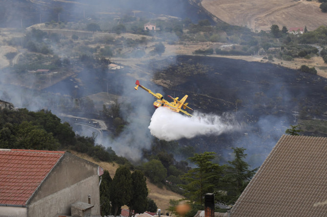 A Canadair drops water on a wildfire in Sicily, Italy, on Aug. 10, 2021. Scientists say there is little doubt that climate change from the burning of fossil fuels is driving heat waves, droughts, wildfires, floods and storms. (AP)