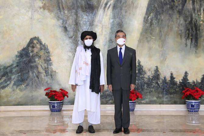 Taliban co-founder Mullah Abdul Ghani Baradar, left, and Chinese Foreign Minister Wang Yi pose for a photo during their meeting in Tianjin, China on July 28, 2021. (Li Ran/Xinhua via AP, File) 
