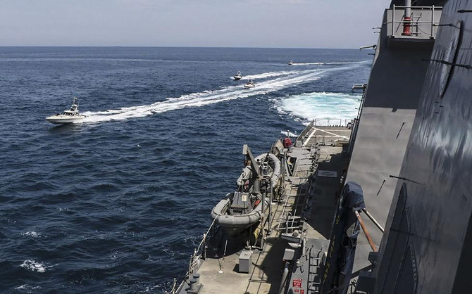 In this photo taken on April 15, 2020, Iranian navy vessels maneuver near US military ships in the Gulf. (US Navy handout photo/file)