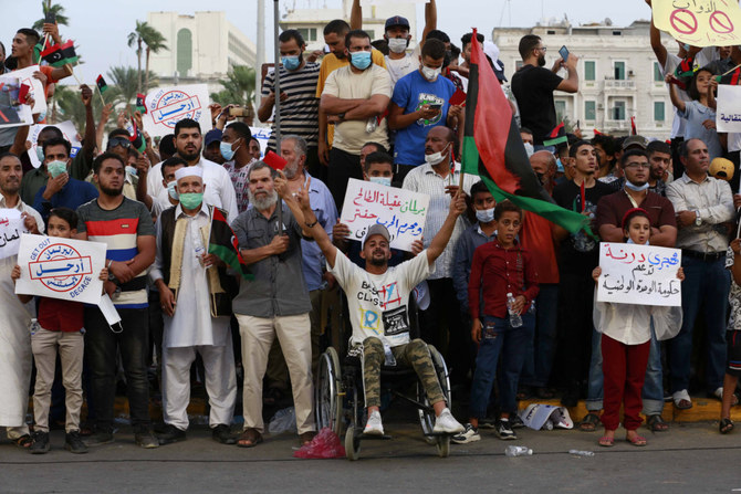 Hundreds of demonstrators protest in Tripoli, Libya, on Sept. 24, 2021, in opposition to the country's parliament passing a vote of no-confidence in the transitional government.(AP Photo/Yousef Murad) 