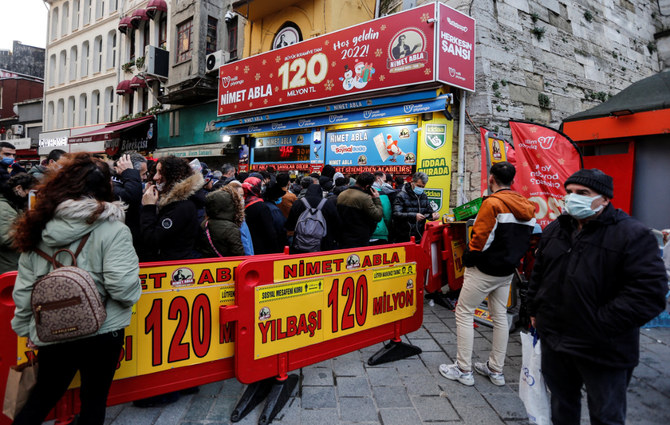 People wait in line to buy tickets in a lottery that has 120 million Turkish lira ($9 million) as the highest reward in front of a vendor in Istanbul, Turkey, on Dec. 30, 2021. (REUTERS/Dilara Senkaya)