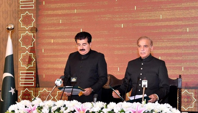 Mian Mohammed Shehbaz Sharif, right, takes oath as the new prime minister of Pakistan. (Reuters)
