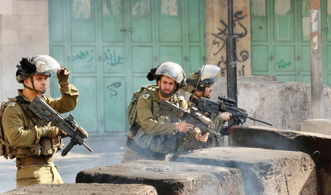Israeli security forces take position amid clashes with Palestinian protesters in Hebron in the occupied West Bank. (AFP)