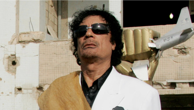 Libya's former President  Gaddafi listens to national anthems at Bab Azizia Palace in Tripoli. (REUTERS)
