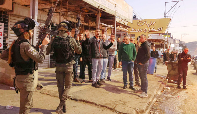 Palestinians react against an Israeli search in the occupied West Bank city of Hawara, on December 2, 2022. (AFP)