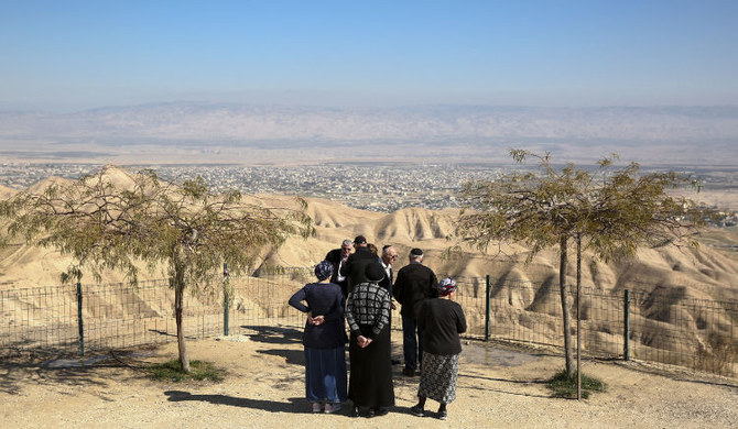 Jewish settlers stand at a view point overlooking the West Bank city of Jericho from the Jewish settlement of Mitzpe Yeriho. (AP
