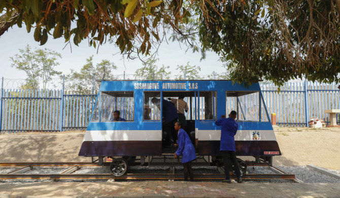 Students of Soshanguve technical high school clean a solar-powered train built by them, in Pretoria. (AFP)