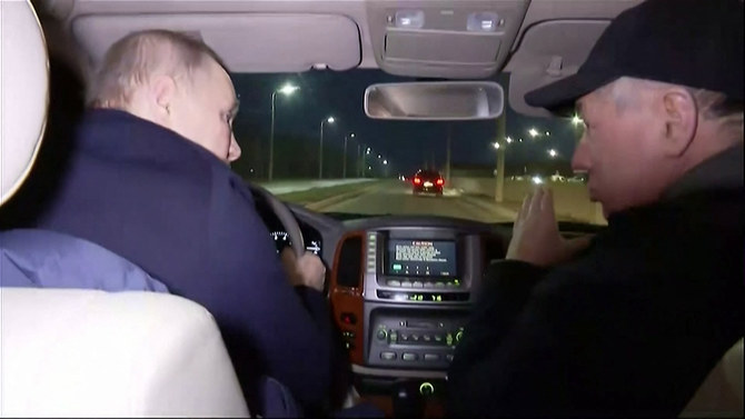 Russia's Vladimir Putin (L) driving with Deputy Prime Minister Marat Khusnullin as he visits Mariupol March 18, 2023. (AFP)