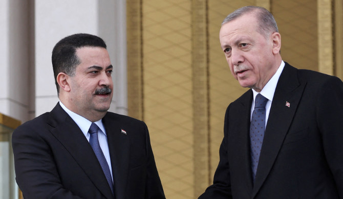 Turkish President Recep Tayyip Erdogan (R) and Iraqi Prime Minister Mohammed Shia' Al Sudani (L) shake hands in Ankara. (AFP)