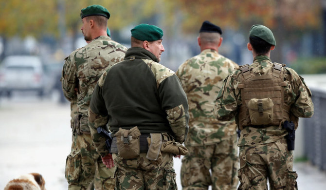 Hungarian soldiers belonging to NATO's peacekeeping mission KFOR walk on a bridge in Kosovo, November 22, 2022. (REUTERS)