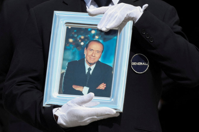 A pallbearer holds a portrait of former Italian PM Silvio Berlusconi during his state funeral in Milan June 14, 2023. (REUTERS)