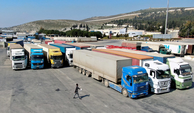 Trucks carrying aid from the UN World Food Programme, following a deadly earthquake, are parked at Bab al-Hawa, Feb. 20, 2023. (