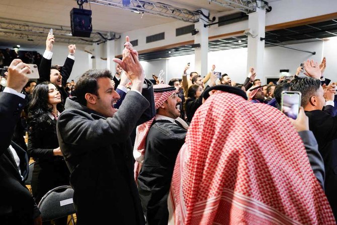 Members of Saudi Royal Commission for Riyadh City celebrate after winning the host of the 2030 World Expo. (AFP)